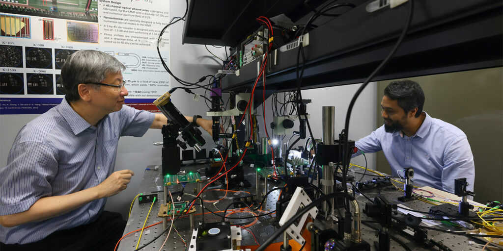 Professor Tsang converses with one of the students in his research team